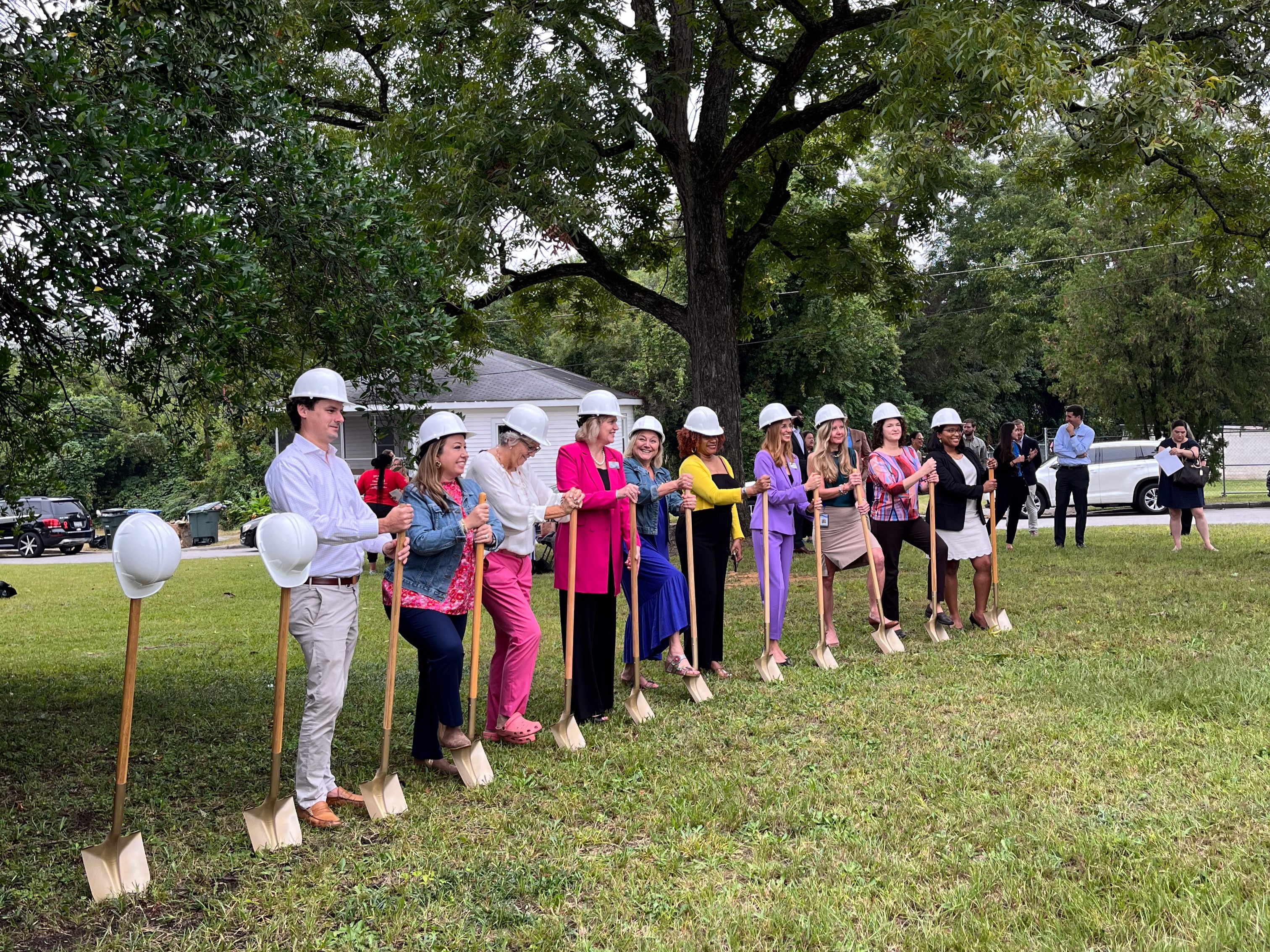 Representatives from Mirci, United Way of the Midlands, and other community partners use shovels to officially break ground on Millwood Place