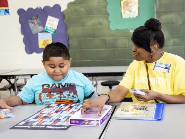 a young boy reading with an MRC one-on-one Reading Volunteer