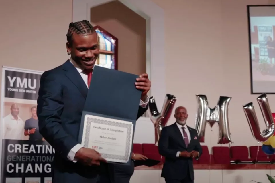 graduate smiling with certificate